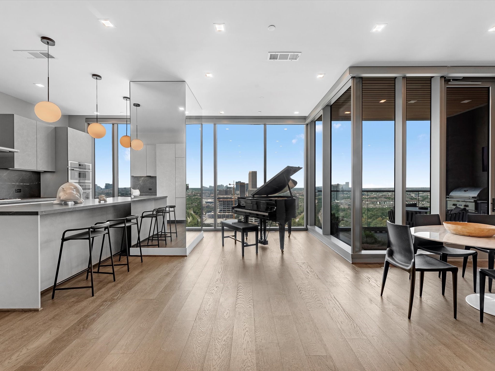 1711 Allen Parkway, Unit 2102 Houston, TX 77019 - Photo 2 of 17 an open kitchen with dining table and chairs