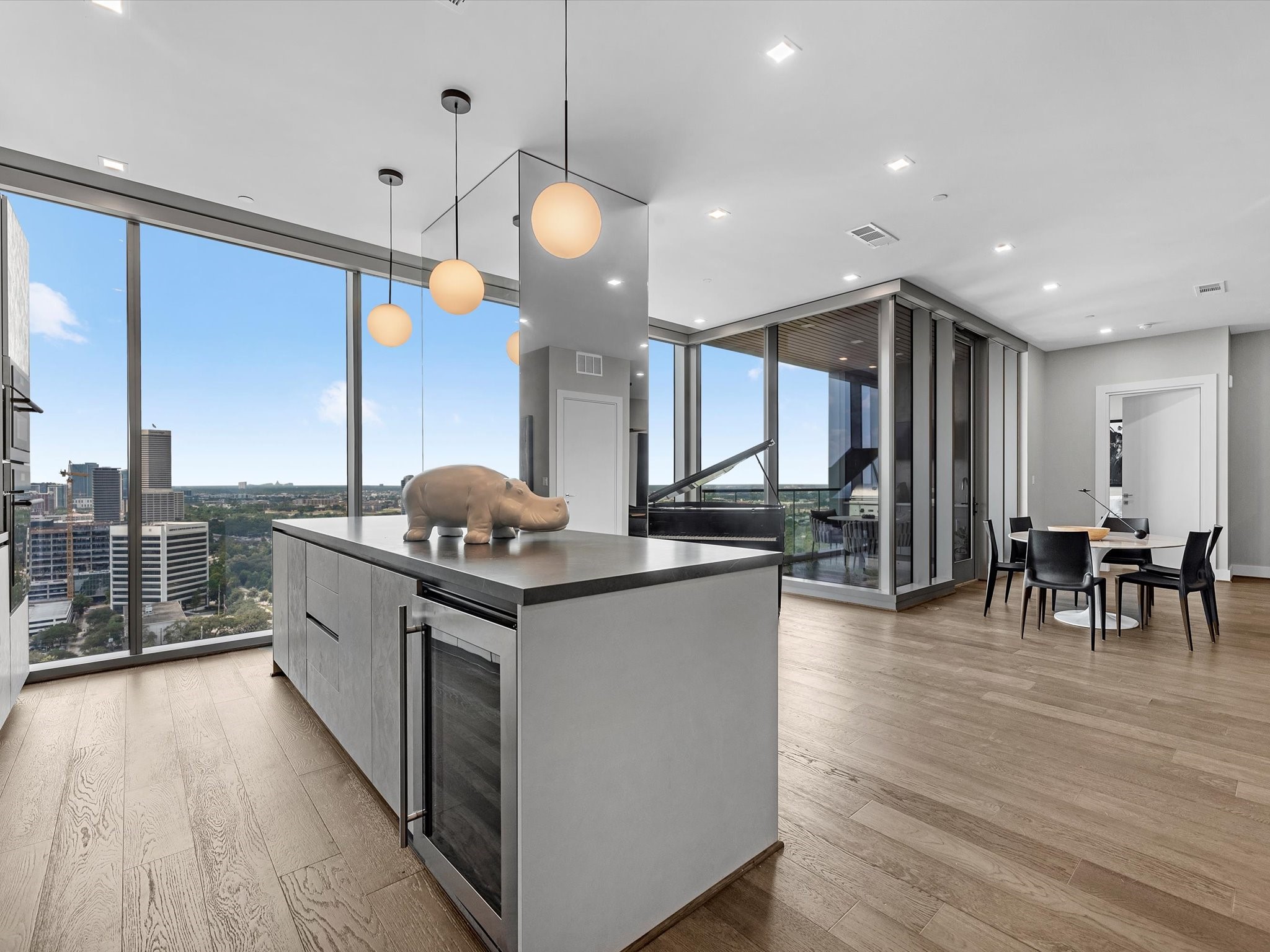1711 Allen Parkway, Unit 2102 Houston, TX 77019 - Photo 5 of 17 a kitchen with stainless steel appliances granite countertop a stove and chairs with wooden floors