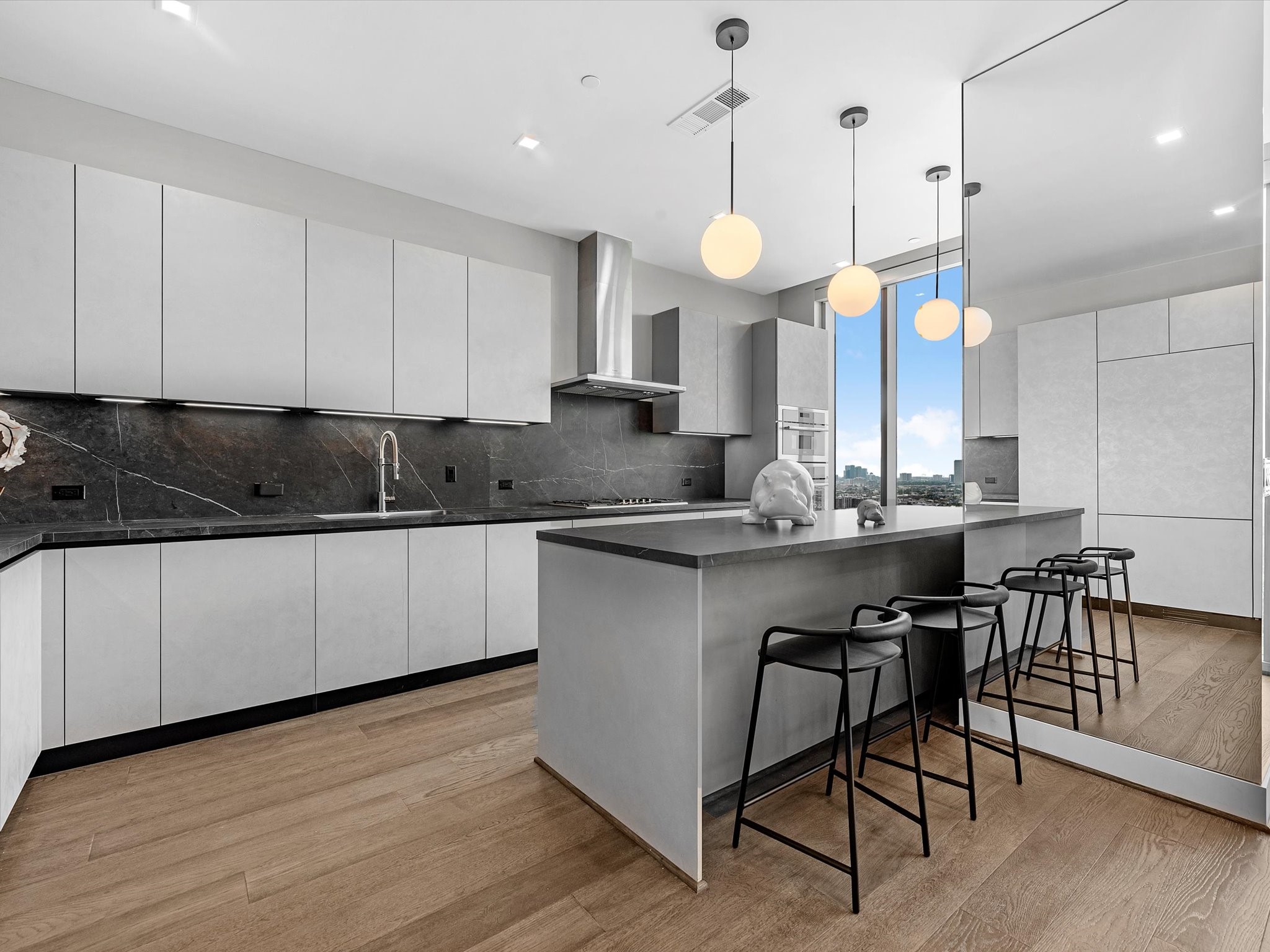 1711 Allen Parkway, Unit 2102 Houston, TX 77019 - Photo 6 of 17 a kitchen with a sink cabinets and wooden floor