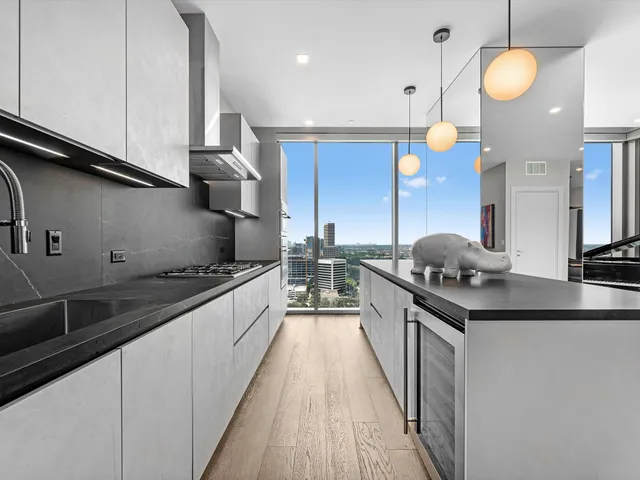 a kitchen with stainless steel appliances granite countertop a stove and a sink