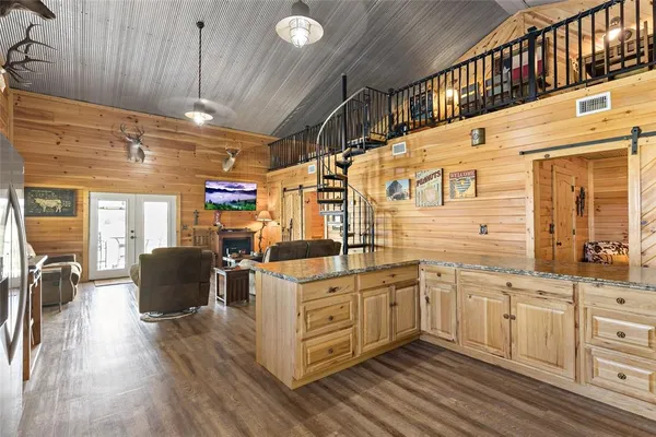 a kitchen with a cabinets and wooden floor