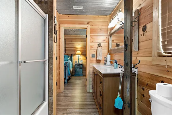 a bathroom with a sink a toilet and shower