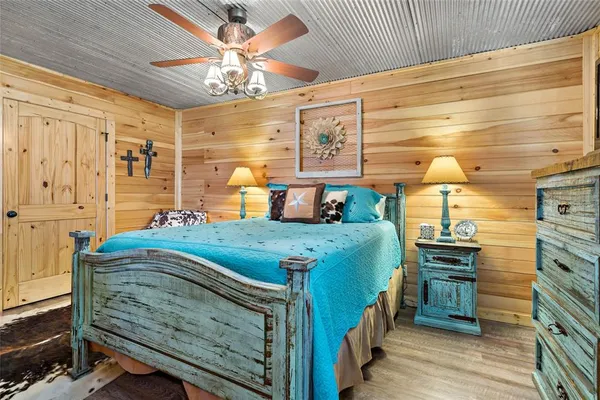 a bedroom with a bed and a chandelier