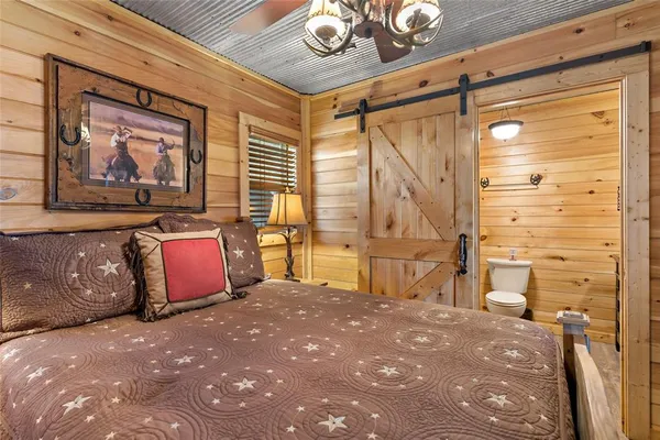 a spacious bedroom with a bed dresser and a window