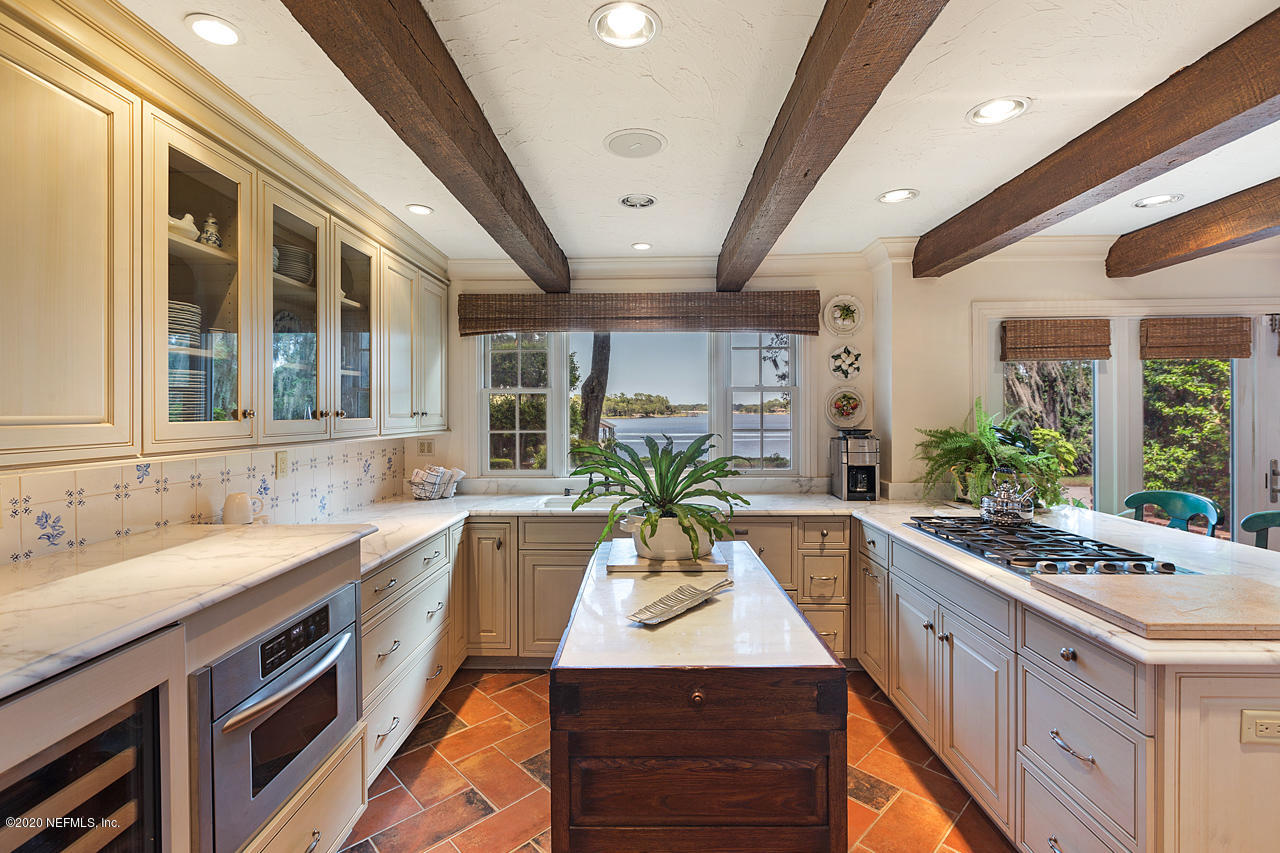 5015 River Point Road Jacksonville, FL 32207 - Photo 11 of 49 a view of a kitchen with a sink and large windows