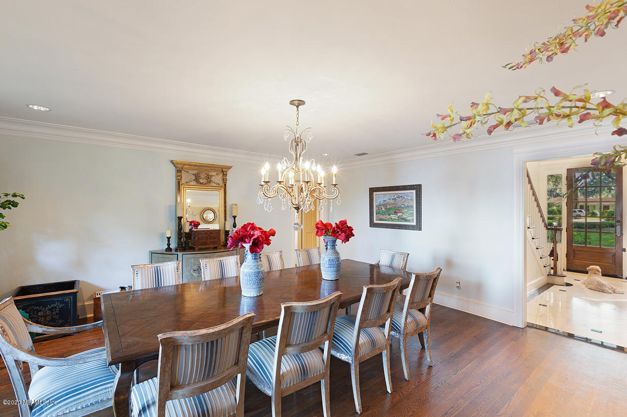 5015 River Point Road Jacksonville, FL 32207 - Photo 15 of 49 a dining room with furniture a chandelier and wooden floor