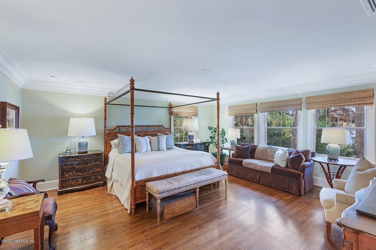 5015 River Point Road Jacksonville, FL 32207 - Photo 16 of 49 a bedroom with a bed couch and large window