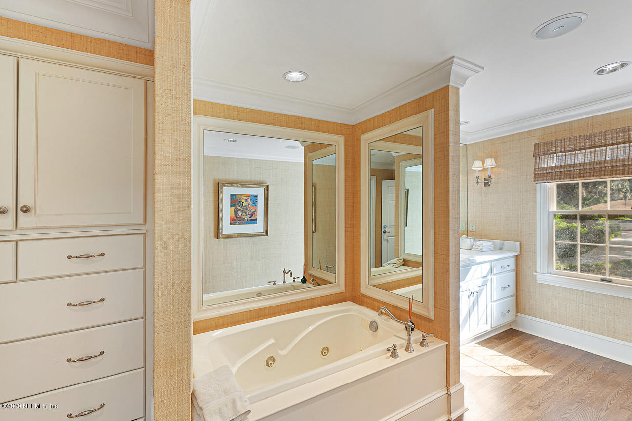 5015 River Point Road Jacksonville, FL 32207 - Photo 17 of 49 a bathroom with a bathtub and a shower