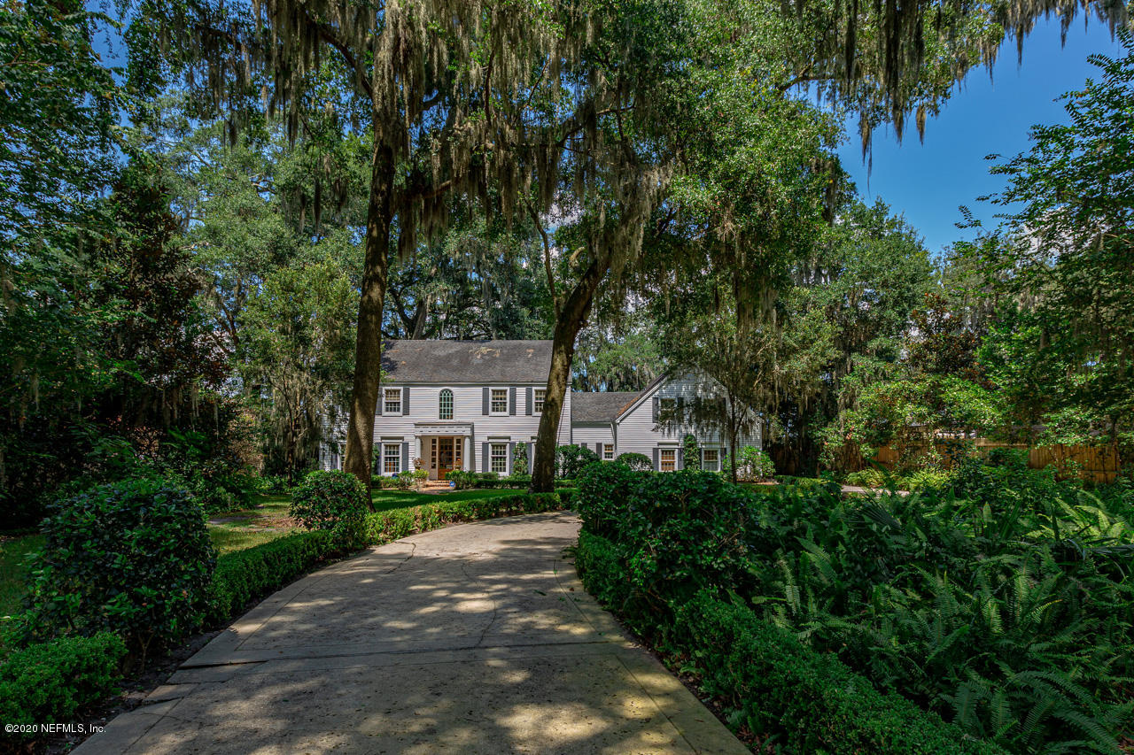 5015 River Point Road Jacksonville, FL 32207 - Photo 2 of 49 a front view of a house with a yard and trees