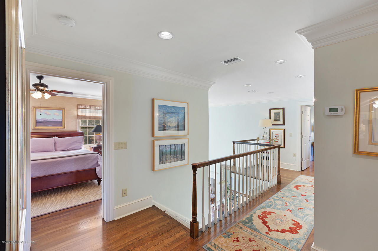 5015 River Point Road Jacksonville, FL 32207 - Photo 21 of 49 a view of a hallway with a bedroom and wooden floor