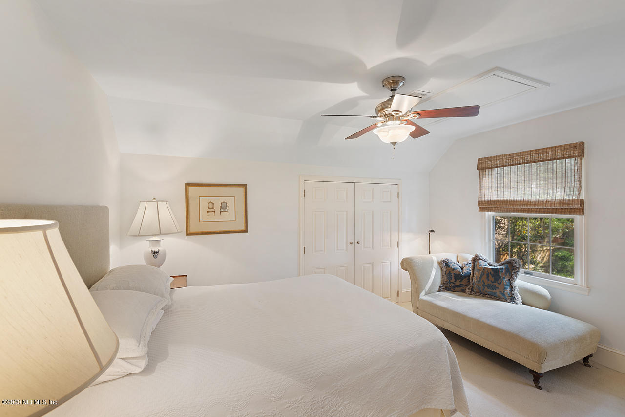 5015 River Point Road Jacksonville, FL 32207 - Photo 26 of 49 a spacious bedroom with a bed couch and window