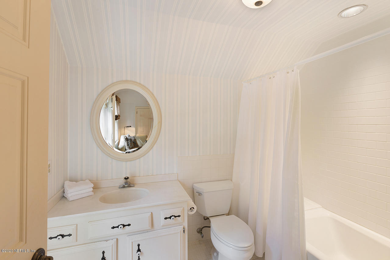5015 River Point Road Jacksonville, FL 32207 - Photo 27 of 49 a bathroom with a toilet a sink and a mirror