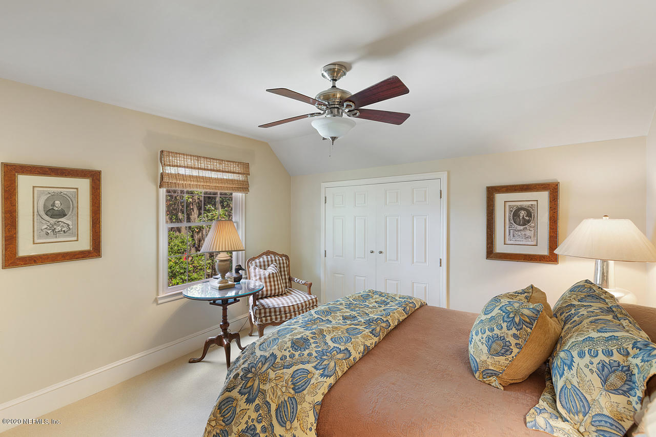 5015 River Point Road Jacksonville, FL 32207 - Photo 28 of 49 a bedroom that has a bed and a chair in it