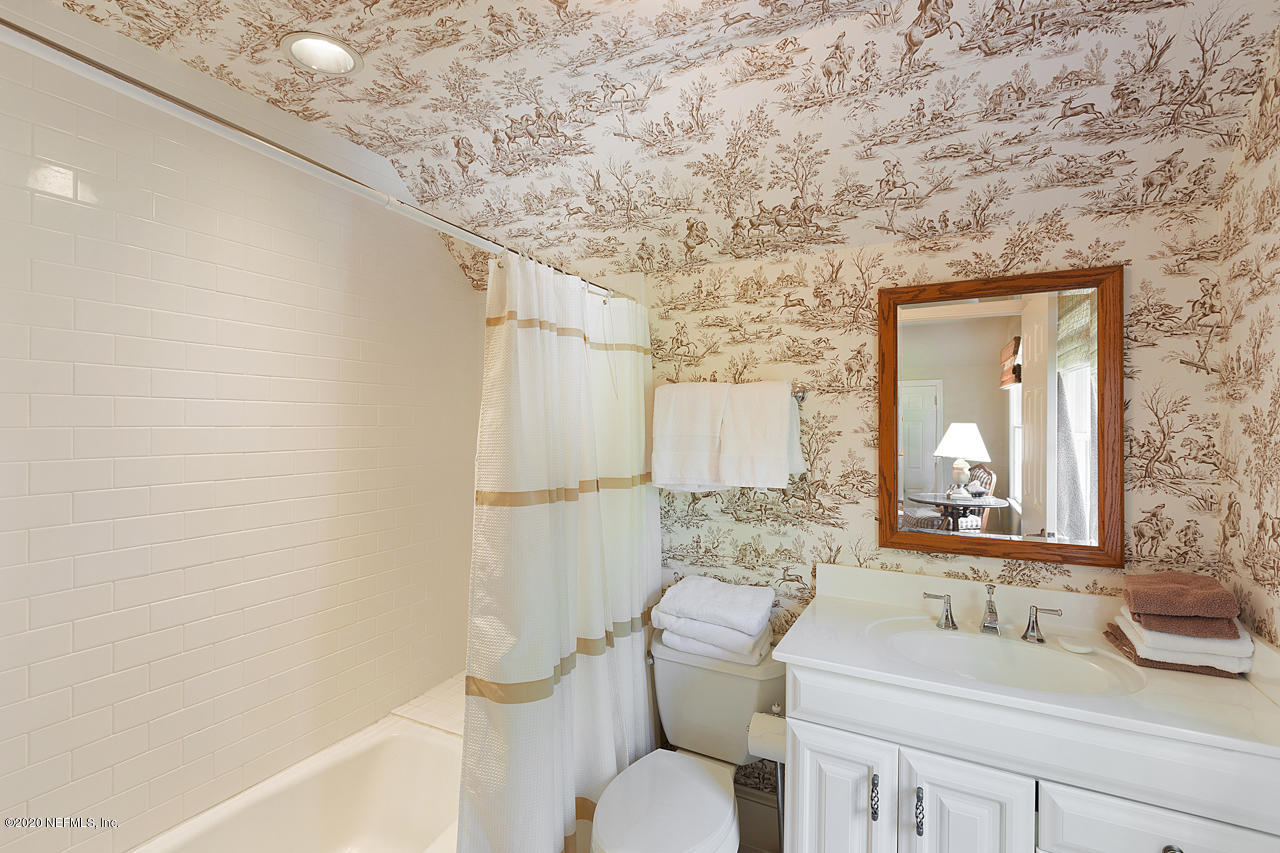 5015 River Point Road Jacksonville, FL 32207 - Photo 29 of 49 a bathroom with a sink and a mirror