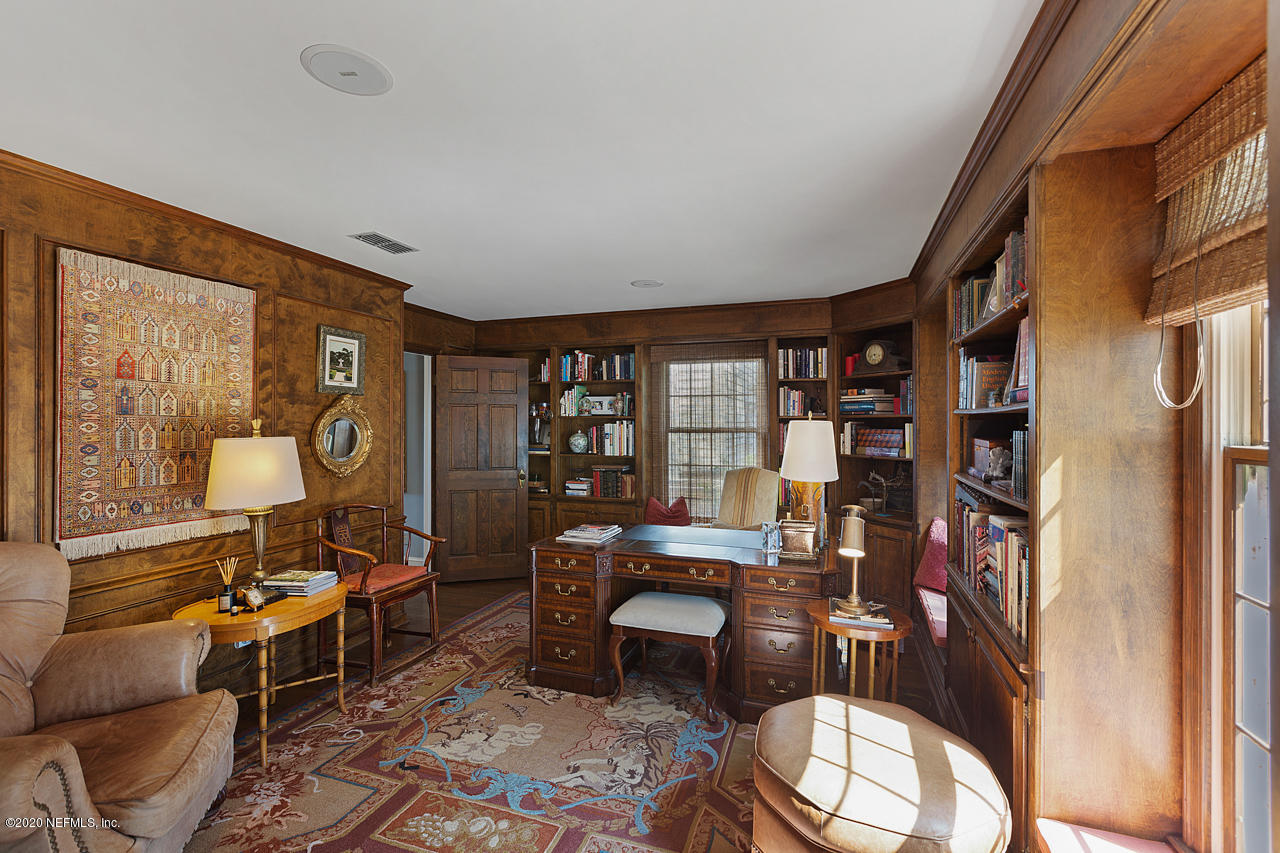 5015 River Point Road Jacksonville, FL 32207 - Photo 30 of 49 a work room with furniture and a bookshelf