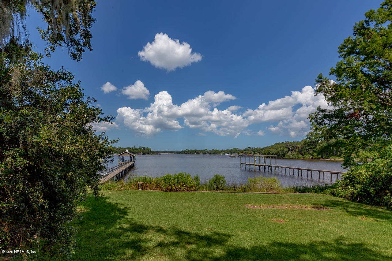 5015 River Point Road Jacksonville, FL 32207 - Photo 38 of 49 a view of a house with a big yard and a fountain