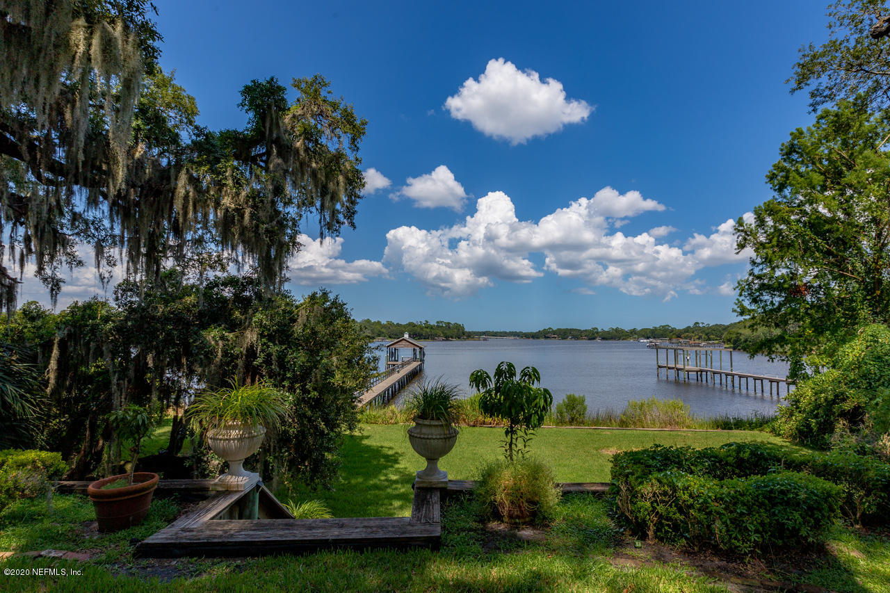5015 River Point Road Jacksonville, FL 32207 - Photo 4 of 49 a view of a house with a yard and potted plants