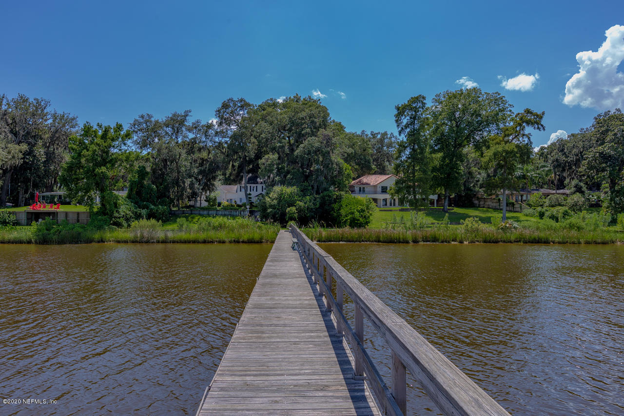 5015 River Point Road Jacksonville, FL 32207 - Photo 41 of 49 a wooden pier with boats in a lake