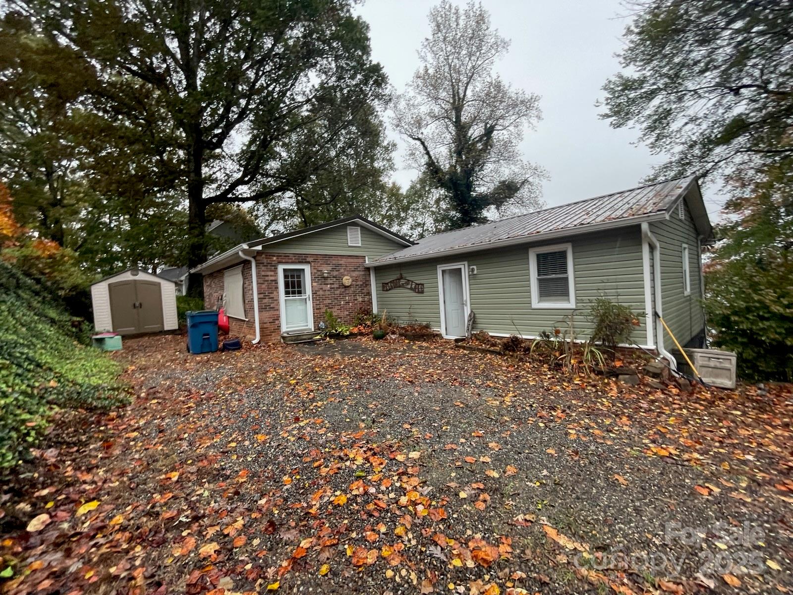 a view of house with a backyard