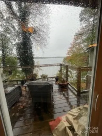 a view of balcony with two chairs and a rug