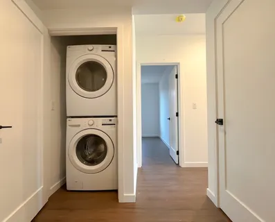a view of a hallway with washer and dryer