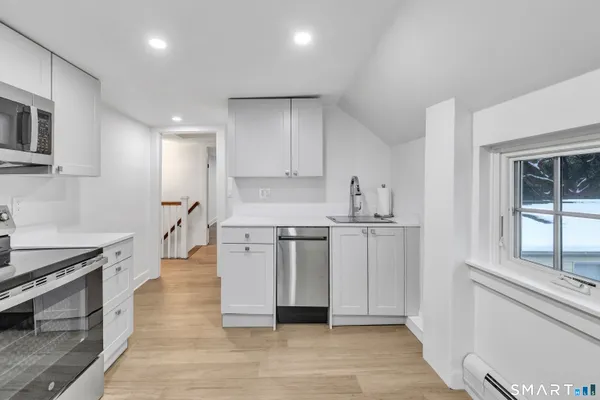 a kitchen with stainless steel appliances a refrigerator sink and stove