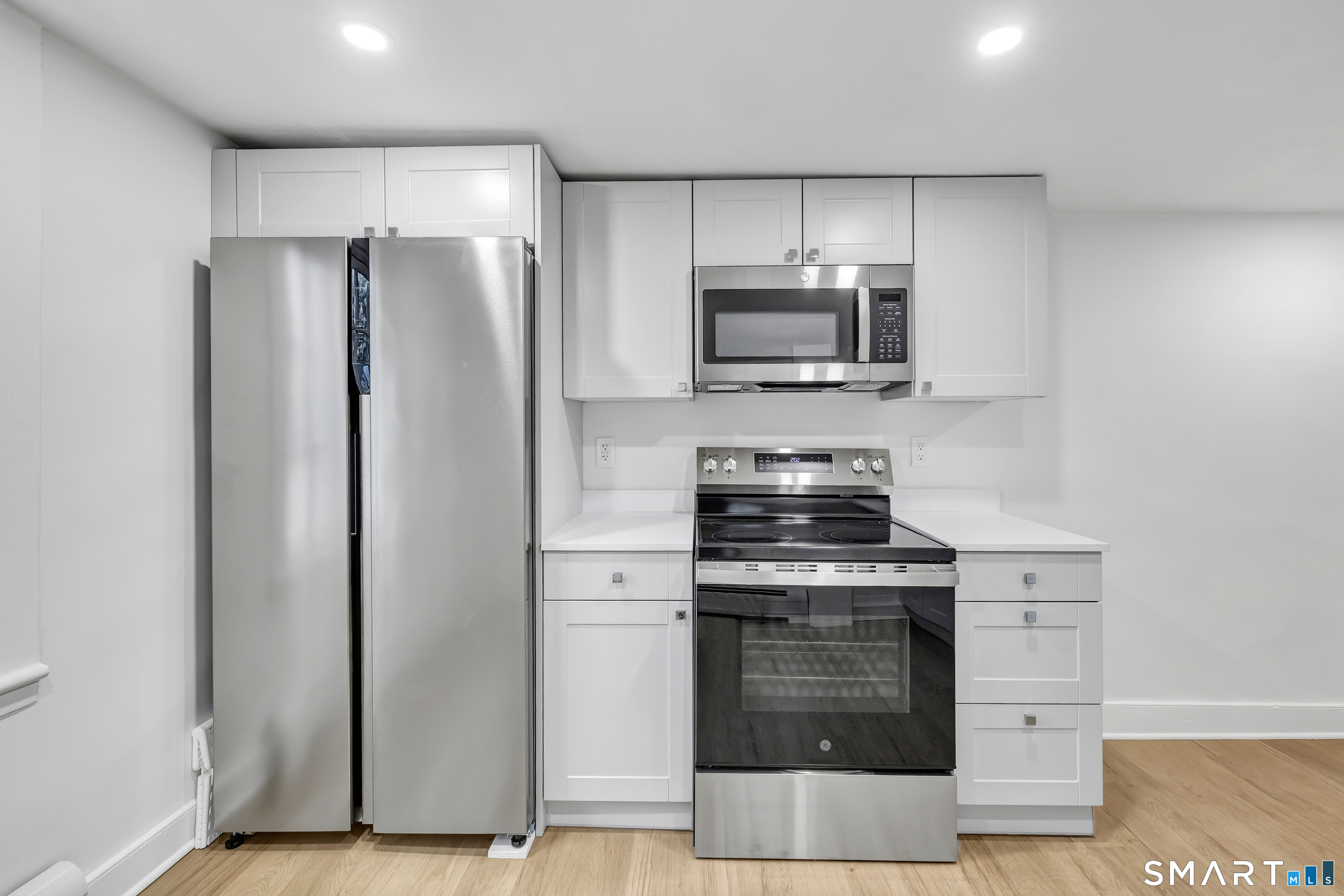 315 Main Street Westport, CT 06880 - Photo 4 of 19 a kitchen with stainless steel appliances granite countertop a stove a refrigerator and a microwave