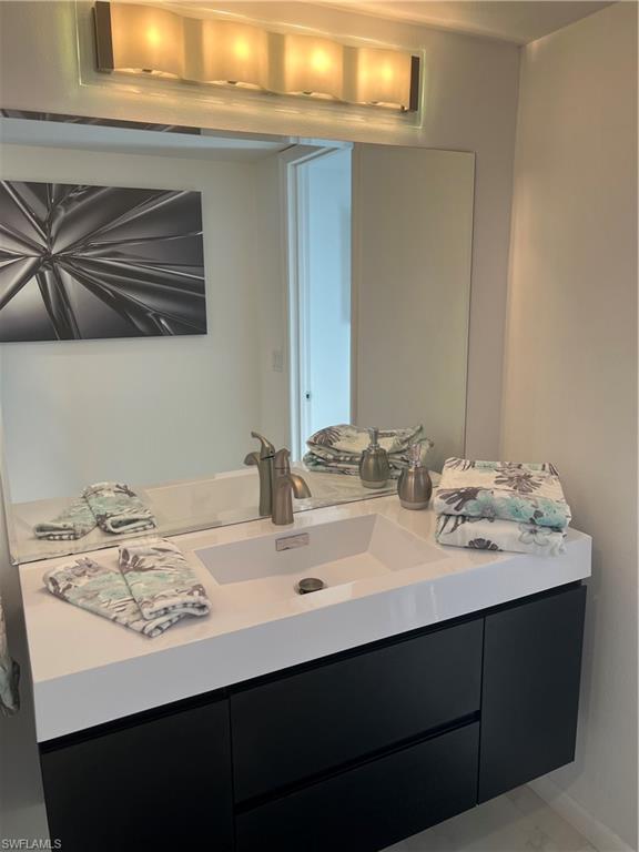 348 Tern Drive, Unit 2 Naples, FL 34112 - Photo 12 of 28 a bathroom with a sink and a mirror