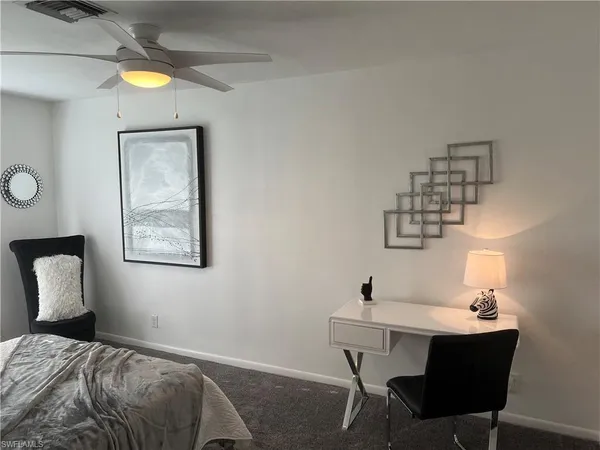 a bedroom with a table and chairs