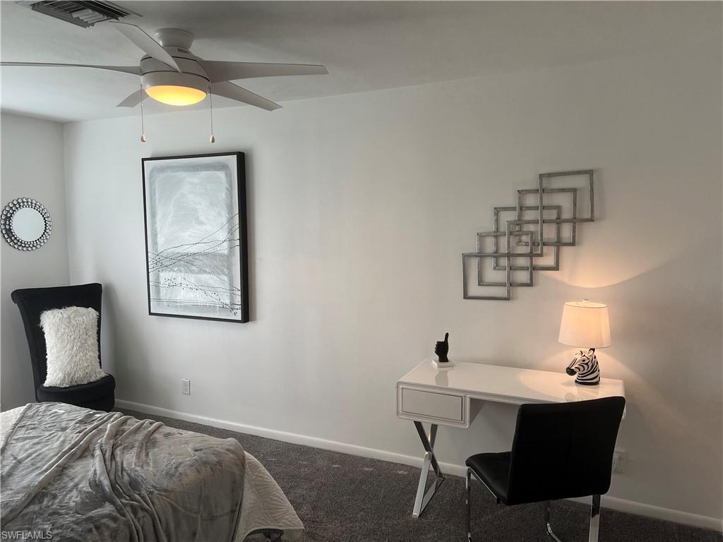 348 Tern Drive, Unit 2 Naples, FL 34112 - Photo 13 of 28 a bedroom with a table and chairs
