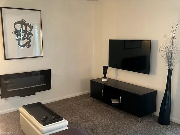 a living room with a flat screen tv and a fireplace