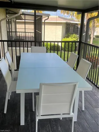 a balcony view with a seating space