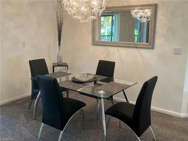 a view of a dining room with furniture and window