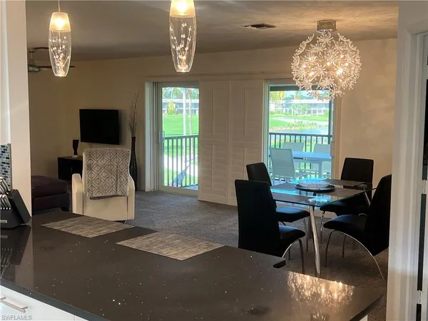 a view of a livingroom with furniture and a chandelier