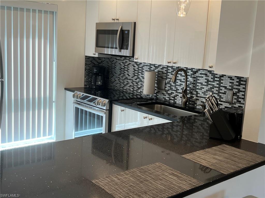 348 Tern Drive, Unit 2 Naples, FL 34112 - Photo 6 of 28 a kitchen with a sink and cabinets