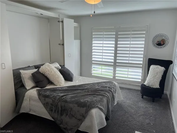 a bedroom with a bed and a chair