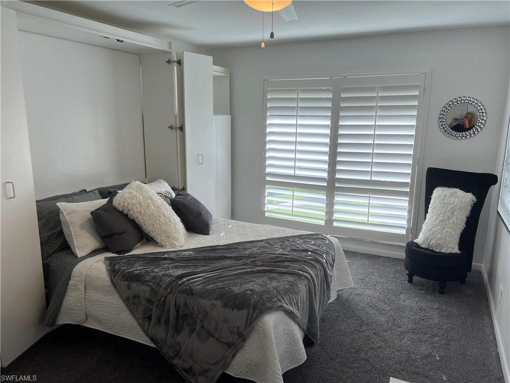 348 Tern Drive, Unit 2 Naples, FL 34112 - Photo 8 of 28 a bedroom with a bed and a chair