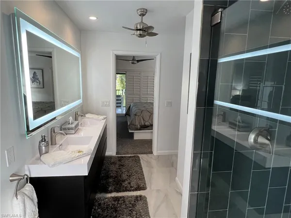 a en suite bathroom with a sink and a mirror