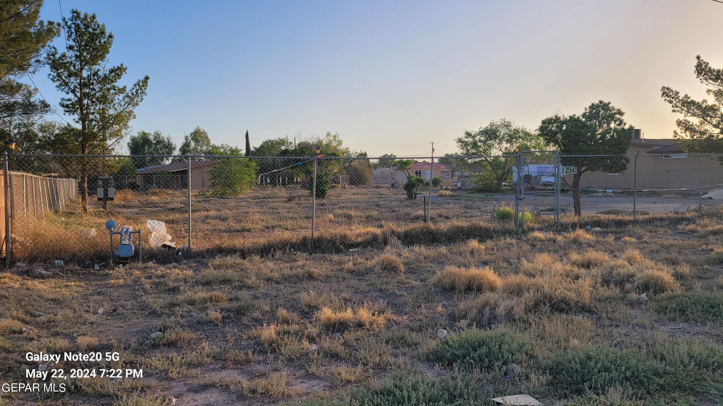 12940 Cuadrilla Road San Elizario, TX 79849 - Photo 8 of 22 a view of a dry yard with trees and stairs