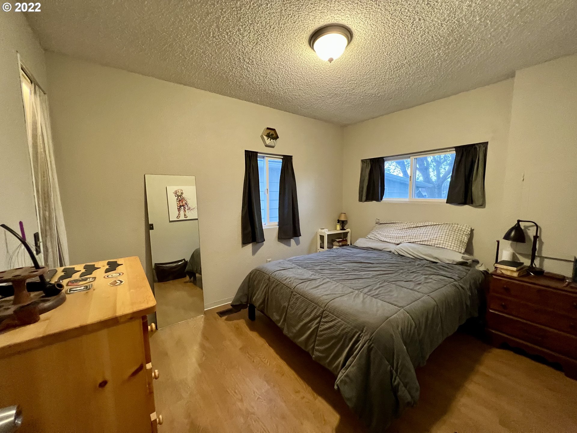 620 Highway 11 Pendleton, OR 97801 - Photo 15 of 26 a bedroom with a bed and wooden floor