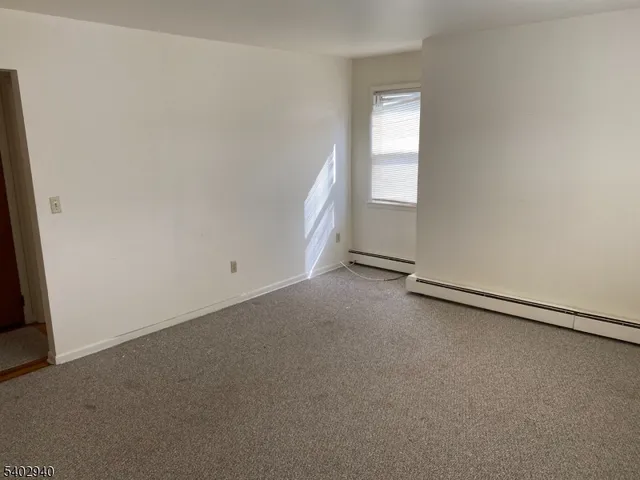 an empty room with a empty space and windows