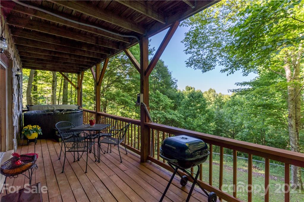 602 Quail Cove Road Clyde, NC 28721 - Photo 42 of 48 a view of a balcony with chairs and wooden floor