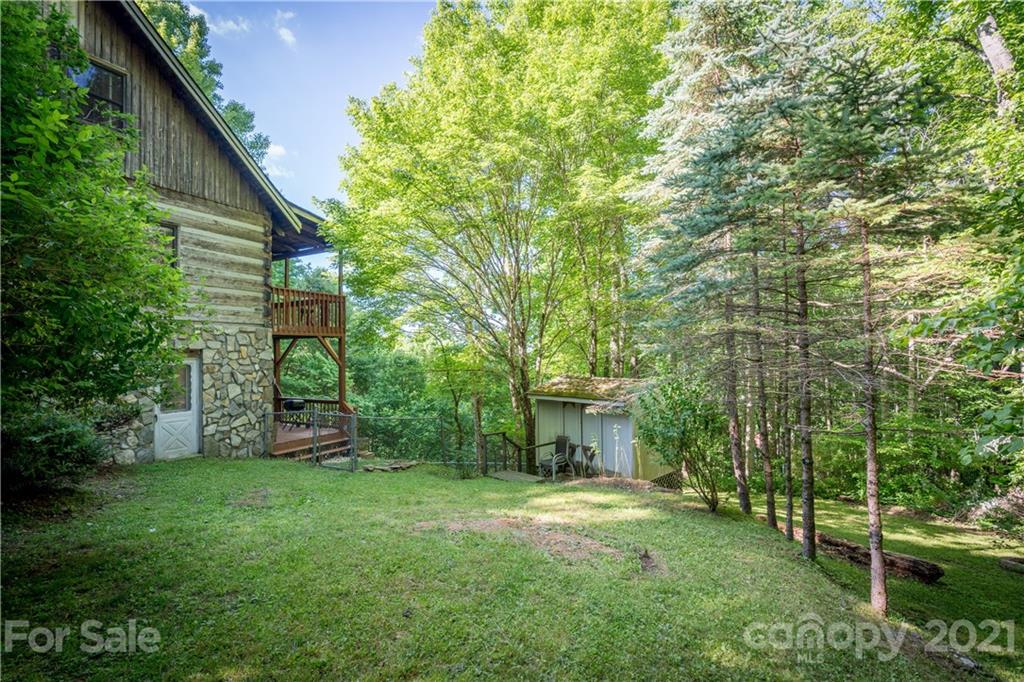602 Quail Cove Road Clyde, NC 28721 - Photo 45 of 48 a view of an house with backyard space and garden
