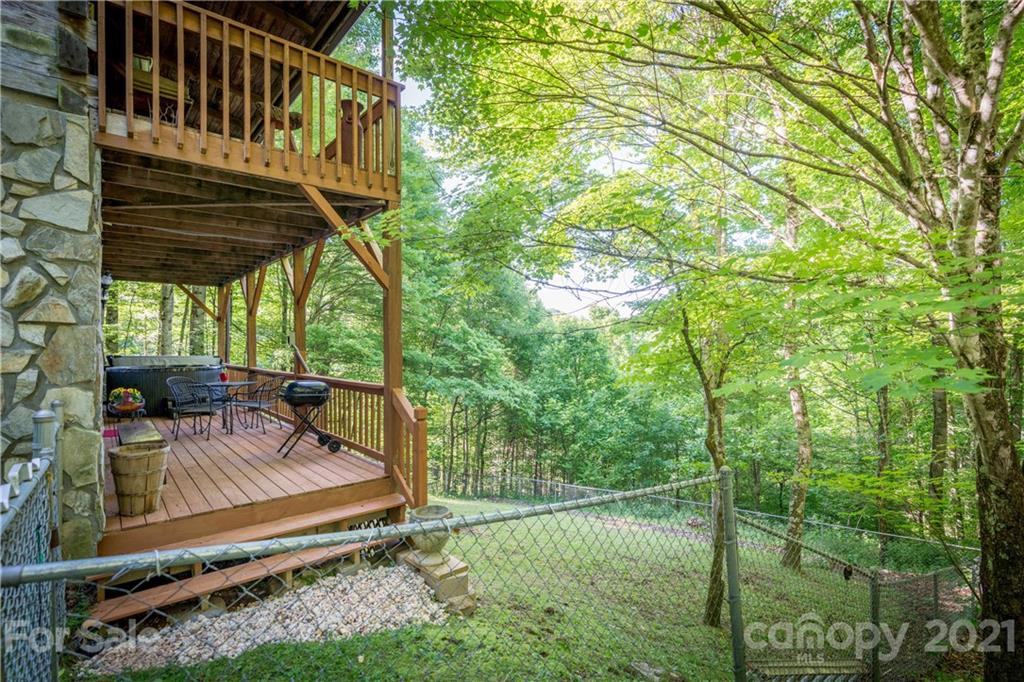 602 Quail Cove Road Clyde, NC 28721 - Photo 46 of 48 a view of a roof deck with couches and wooden fence