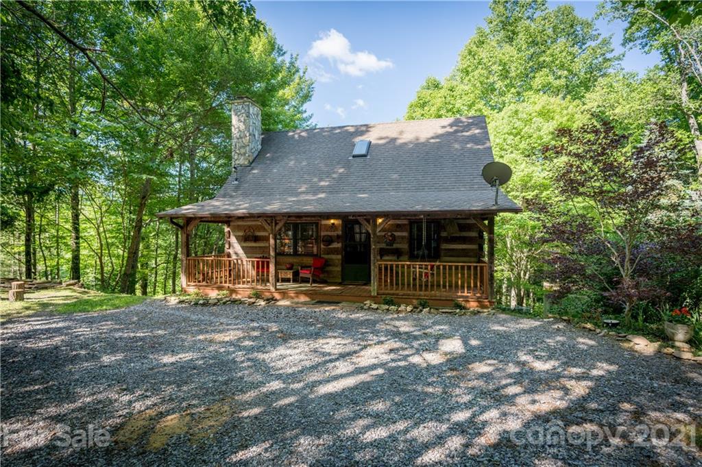 602 Quail Cove Road Clyde, NC 28721 - Photo 8 of 48 a backyard of a house with yard and outdoor seating