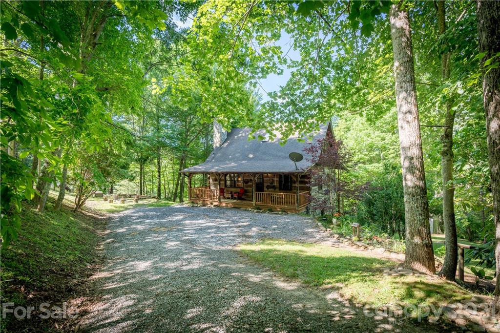 602 Quail Cove Road Clyde, NC 28721 - Photo 10 of 48 a view of a house with a tree in a yard