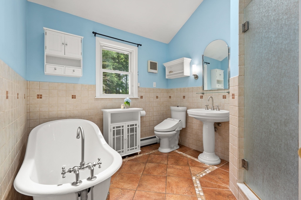 152 Gay Road Groton, MA 01450 - Photo 19 of 38 a spacious bathroom with a toilet sink and mirror