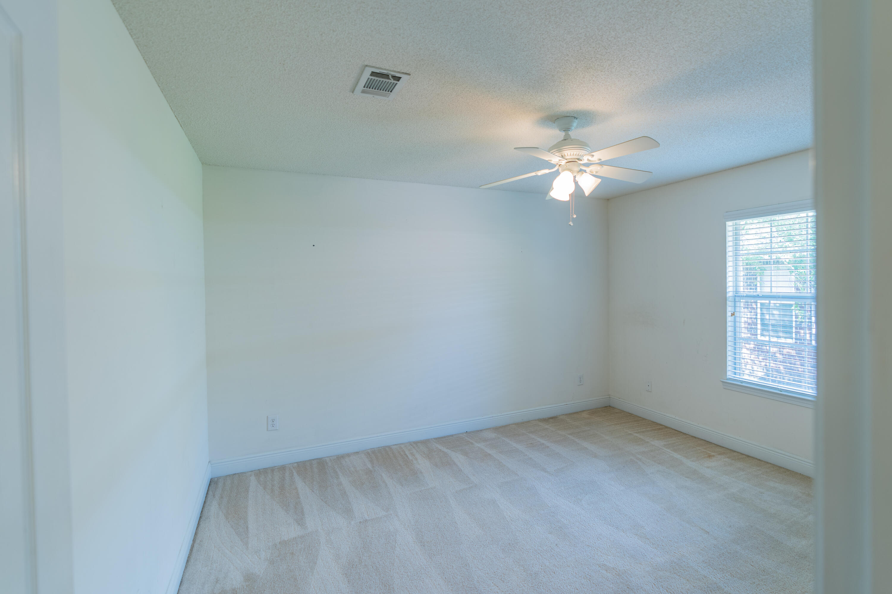 231 Foxchase Way Crestview, FL 32536 - Photo 12 of 30 wooden floor in an empty room with a window