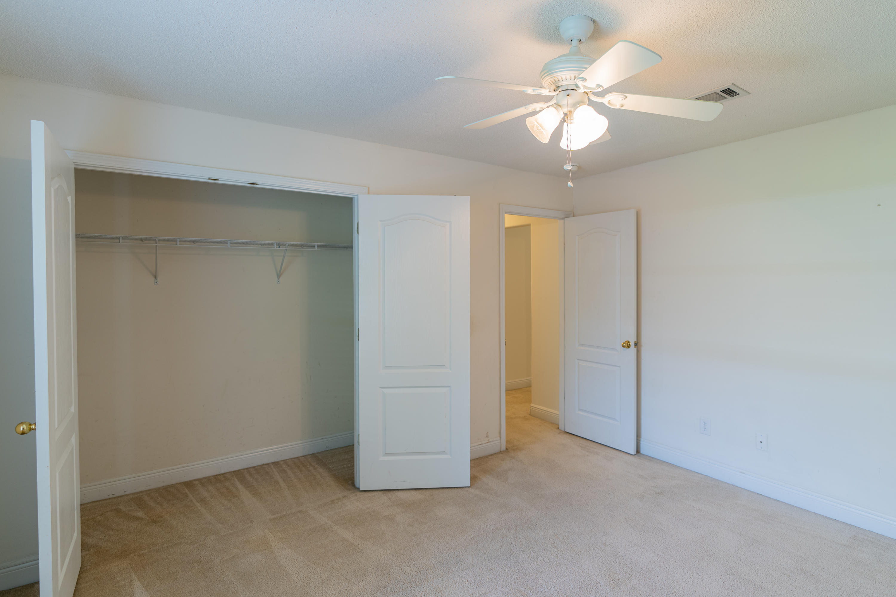 231 Foxchase Way Crestview, FL 32536 - Photo 13 of 30 an empty room with closet and a chandelier fan