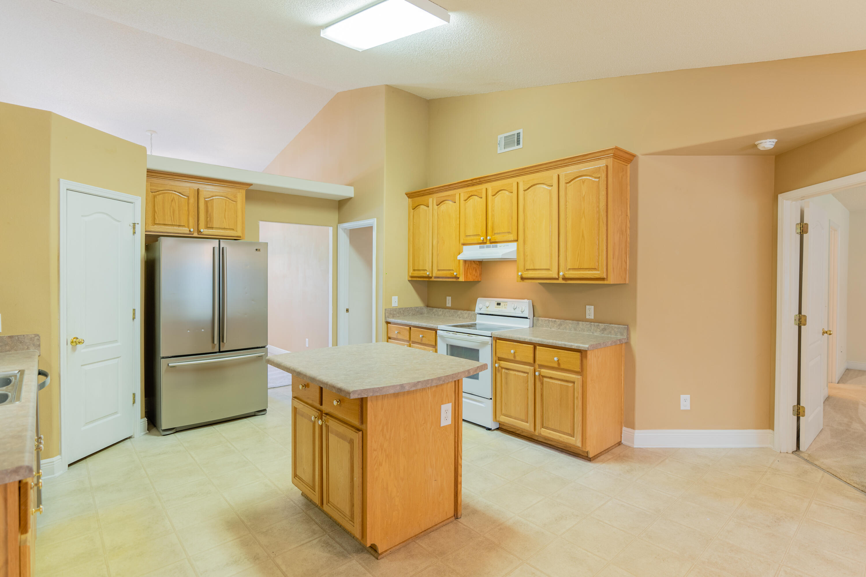 231 Foxchase Way Crestview, FL 32536 - Photo 19 of 30 a kitchen with stainless steel appliances a refrigerator sink and stove